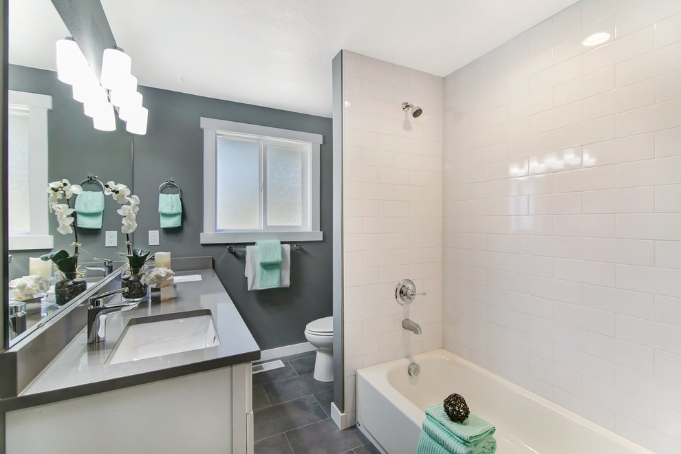 Alcove bathtub - mid-sized transitional kids' white tile and ceramic tile porcelain tile and gray floor alcove bathtub idea in Seattle with shaker cabinets, a two-piece toilet, gray walls, an undermount sink, quartz countertops, gray countertops and white cabinets