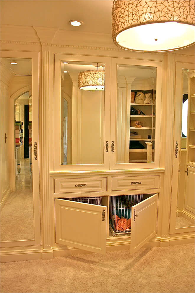 Inspiration for a large traditional gender-neutral walk-in wardrobe in Orange County with white cabinets, carpet, raised-panel cabinets and beige floor.
