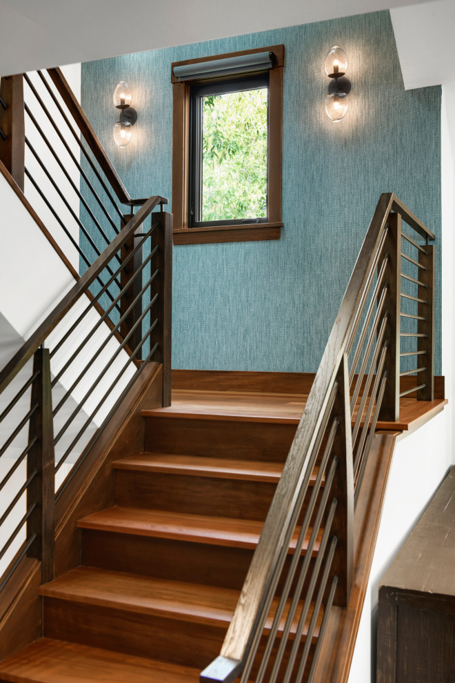 Photo of a wood l-shaped staircase in Minneapolis with wood risers, mixed railing and wallpaper.