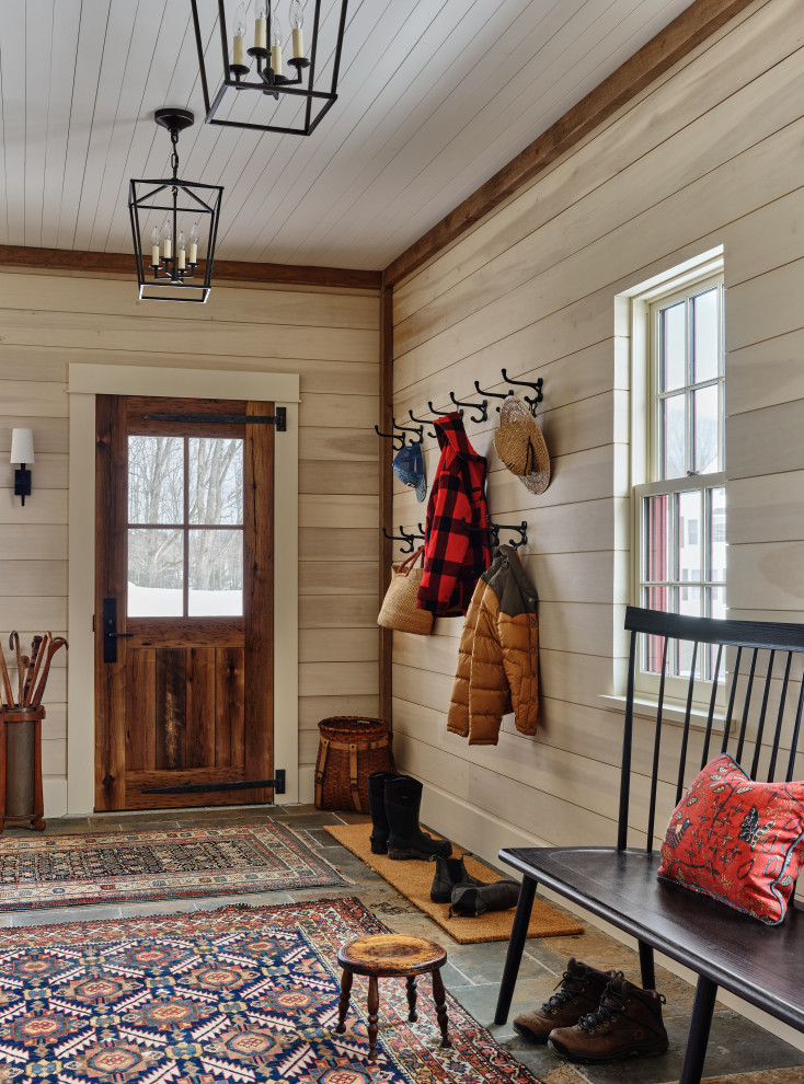Design ideas for a farmhouse foyer in Burlington with beige walls, a single front door, a dark wood front door, grey floors, a timber clad ceiling and wood walls.