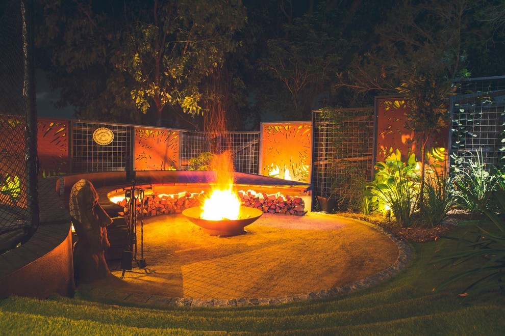 Photo of a contemporary backyard garden in Other with a fire feature and gravel.