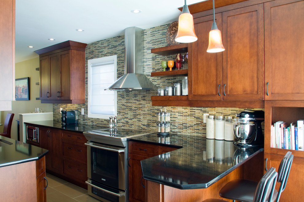 Photo of a transitional galley kitchen in Ottawa with a single-bowl sink, shaker cabinets, medium wood cabinets, granite benchtops, multi-coloured splashback, ceramic splashback, stainless steel appliances, porcelain floors and a peninsula.