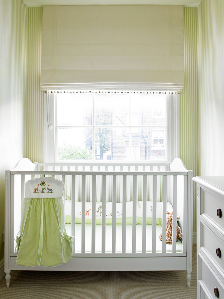 Photo of a traditional gender-neutral nursery in London with green walls, carpet and beige floor.