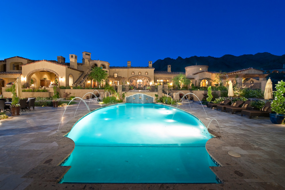 Pool fountain - huge mediterranean backyard stone and rectangular lap pool fountain idea in Phoenix