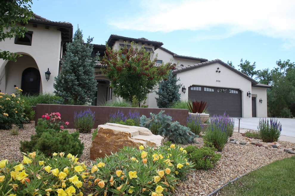 This is an example of a mid-sized mediterranean front yard full sun driveway for summer in Denver.