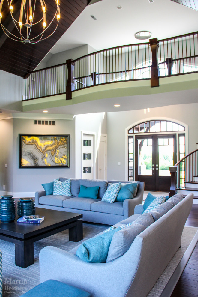 Example of a large transitional dark wood floor and vaulted ceiling foyer design with gray walls and a dark wood front door