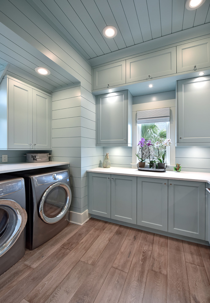 Photo of a beach style laundry room in Charleston with a side-by-side washer and dryer.