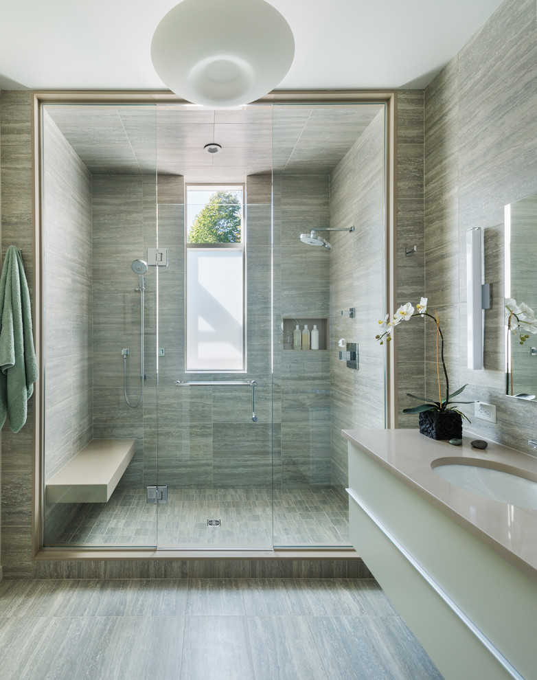 Inspiration for a large contemporary 3/4 bathroom in Boston with flat-panel cabinets, beige cabinets, an alcove shower, a two-piece toilet, beige tile, brown tile, green tile, multi-coloured tile, porcelain tile, beige walls, porcelain floors, an undermount sink, engineered quartz benchtops, multi-coloured floor, a hinged shower door and beige benchtops.