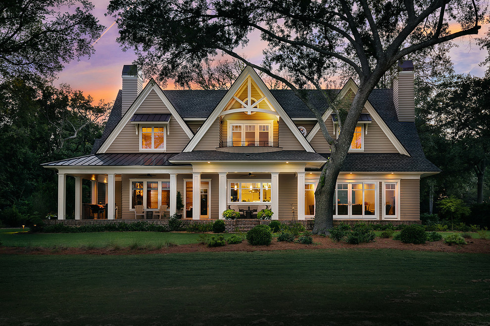 This is an example of a traditional two-storey brown house exterior in Charleston with a gable roof and a shingle roof.