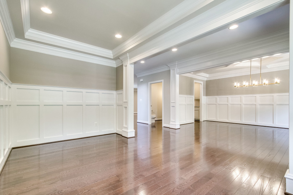 Photo of a mid-sized arts and crafts formal open concept living room in DC Metro with grey walls, dark hardwood floors, no fireplace, brown floor, recessed and decorative wall panelling.
