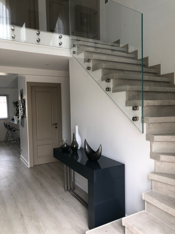 Inspiration for a mid-sized contemporary wooden l-shaped glass railing and wallpaper staircase remodel in Paris with wooden risers