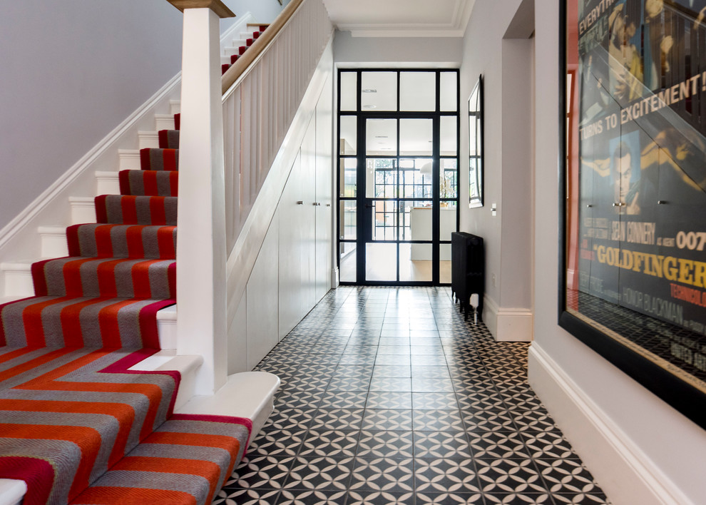 Eclectic hallway in London with ceramic floors.