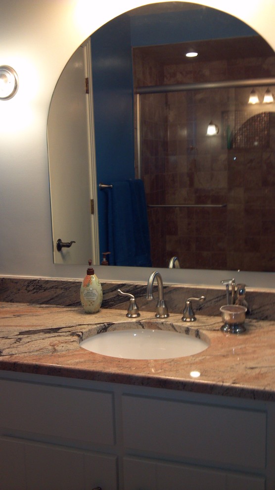 Inspiration for a large transitional master brown tile and ceramic tile alcove shower remodel with an undermount sink, flat-panel cabinets, gray cabinets, granite countertops and white walls