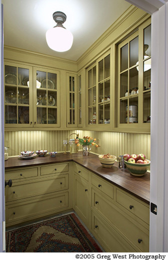 Large country l-shaped kitchen pantry in Boston with beaded inset cabinets, yellow cabinets, wood benchtops and with island.