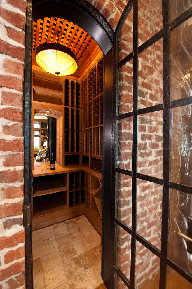This is an example of a small traditional wine cellar in Charleston with storage racks and beige floor.
