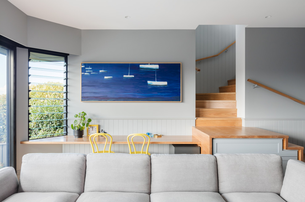 Transitional open concept family room in Sydney with grey walls and decorative wall panelling.