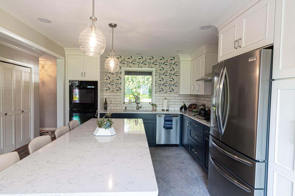 Mid-sized transitional l-shaped porcelain tile and gray floor eat-in kitchen photo with an undermount sink, flat-panel cabinets, white cabinets, quartz countertops, white backsplash, subway tile backsplash, stainless steel appliances, an island and white countertops