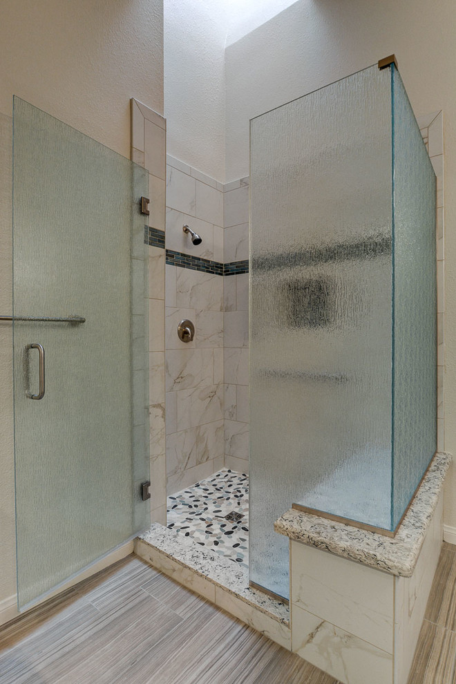 Photo of a contemporary bathroom in Las Vegas with recessed-panel cabinets and quartzite benchtops.