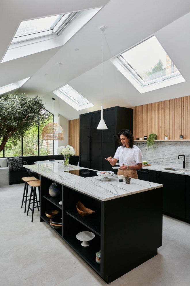 Inspiration for a large scandi open plan kitchen in London with a built-in sink, flat-panel cabinets, black cabinets, quartz worktops, multi-coloured splashback, black appliances, an island and multicoloured worktops.