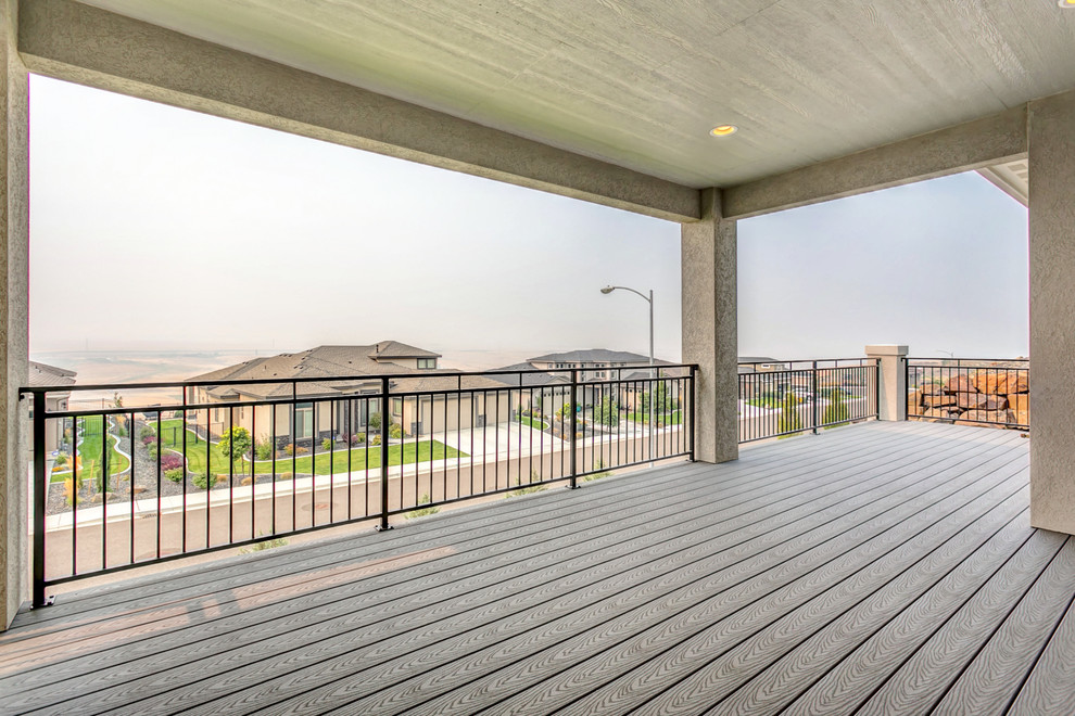 Large transitional backyard deck photo in Seattle with a roof extension