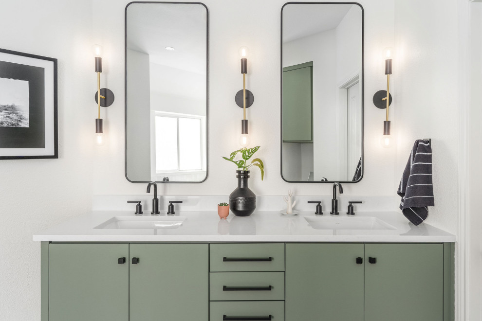 Large modern ensuite bathroom in Austin with flat-panel cabinets, green cabinets, a freestanding bath, all types of shower, white tiles, ceramic tiles, white walls, ceramic flooring, a built-in sink, black floors, an open shower, a wall niche, double sinks and a built in vanity unit.