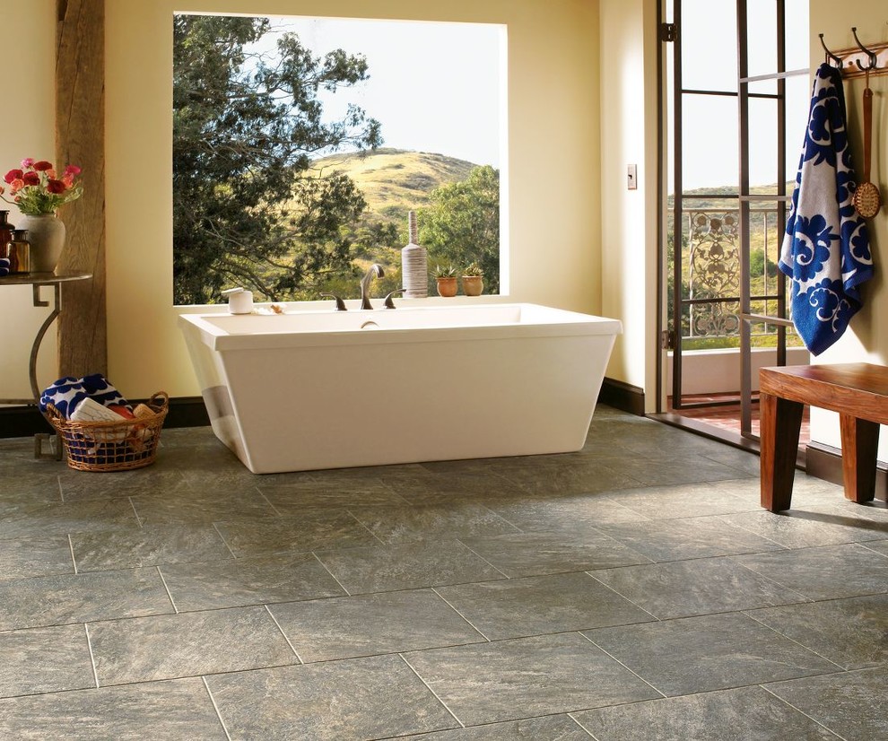 Inspiration for a large transitional master stone tile and gray tile slate floor and gray floor freestanding bathtub remodel with yellow walls