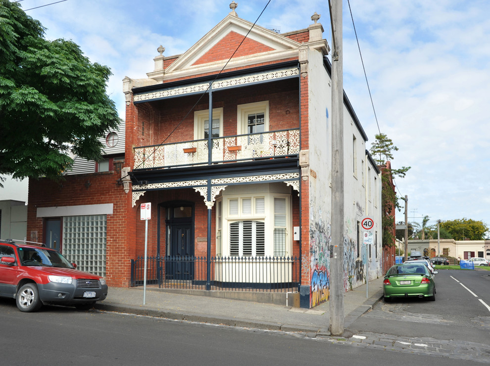 This is an example of a mid-sized traditional two-storey brick red exterior in Melbourne with a hip roof.