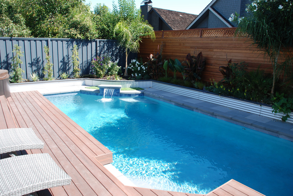 Small contemporary backyard rectangular pool in San Francisco with a water feature and concrete pavers.