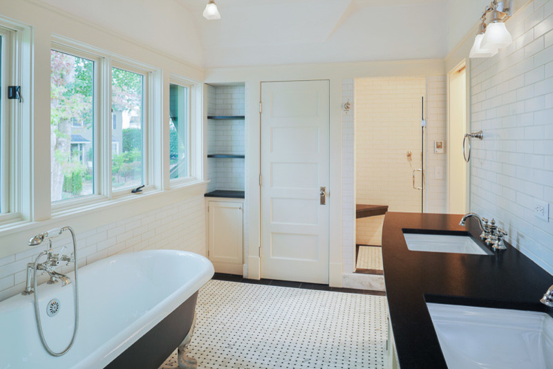 Claw-foot bathtub - transitional master white tile white floor claw-foot bathtub idea in Denver with flat-panel cabinets, white cabinets, white walls, an undermount sink and a hinged shower door