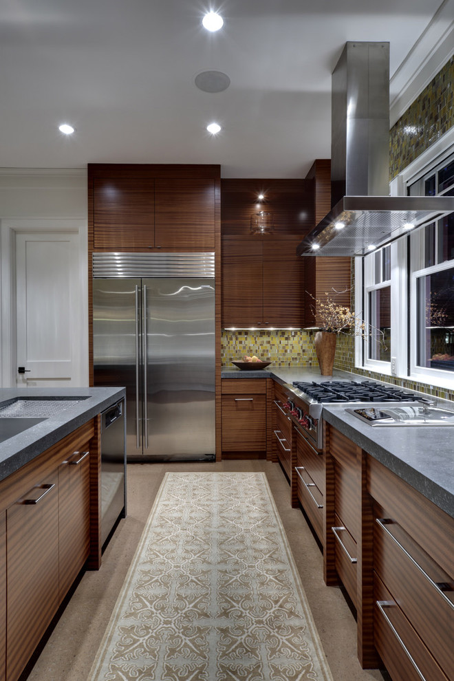 This is an example of a contemporary kitchen in Dallas with mosaic tile splashback, green splashback, flat-panel cabinets, dark wood cabinets, stainless steel appliances and soapstone benchtops.