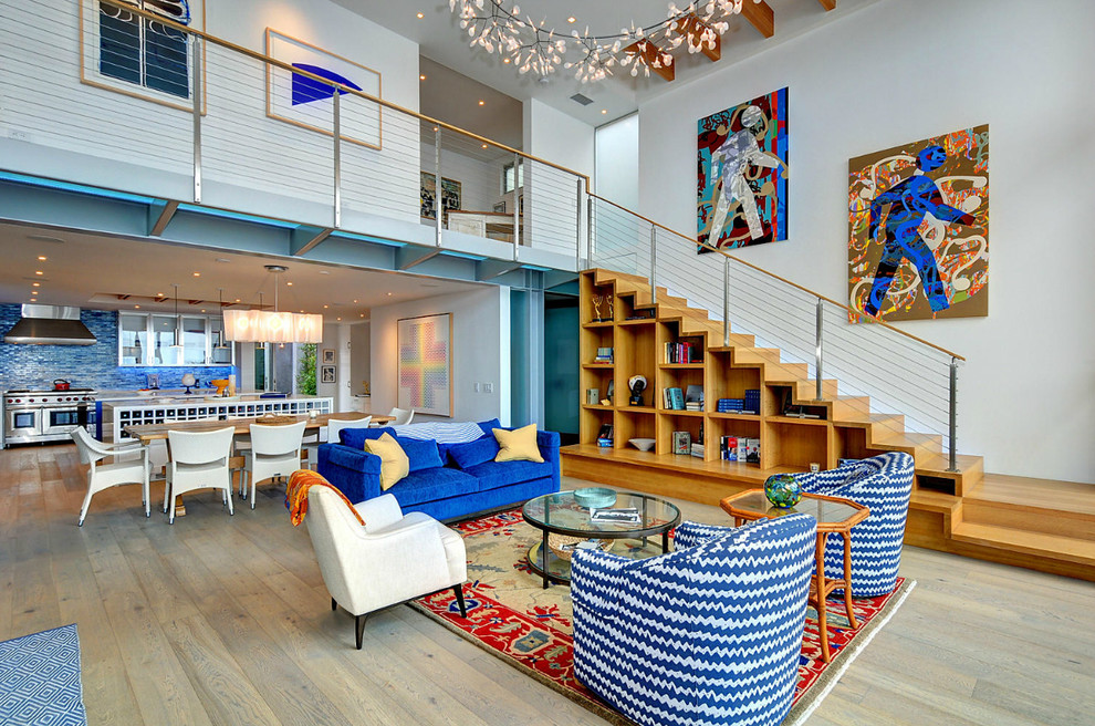 Photo of an expansive beach style open concept living room in Los Angeles with light hardwood floors.