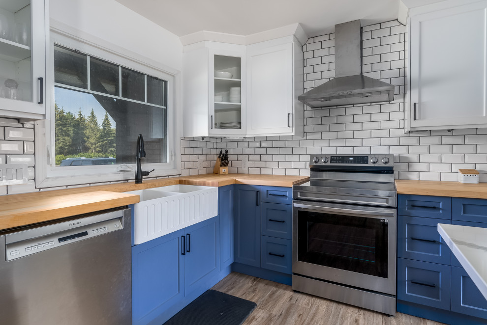 Kitchen - transitional kitchen idea in Edmonton with shaker cabinets, blue cabinets, quartzite countertops, subway tile backsplash, stainless steel appliances, an island and white countertops