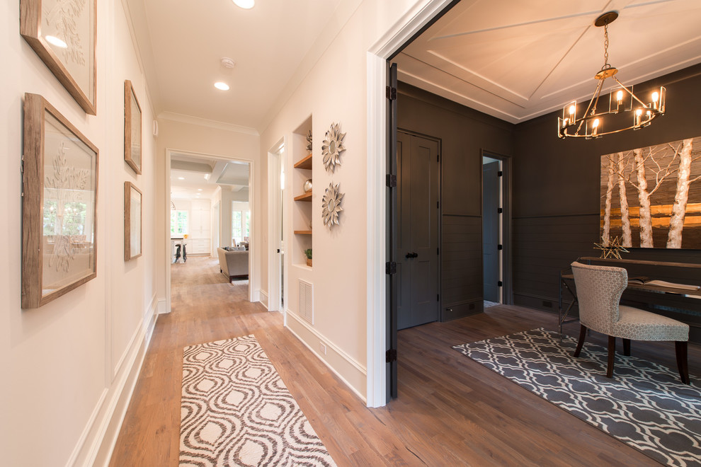 Design ideas for a mid-sized traditional foyer in Charlotte with beige walls, light hardwood floors, a single front door, a light wood front door and beige floor.