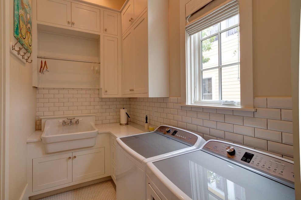 Design ideas for a mid-sized traditional l-shaped dedicated laundry room in Miami with shaker cabinets, white cabinets, quartz benchtops, beige walls, porcelain floors, a side-by-side washer and dryer, white floor and an utility sink.