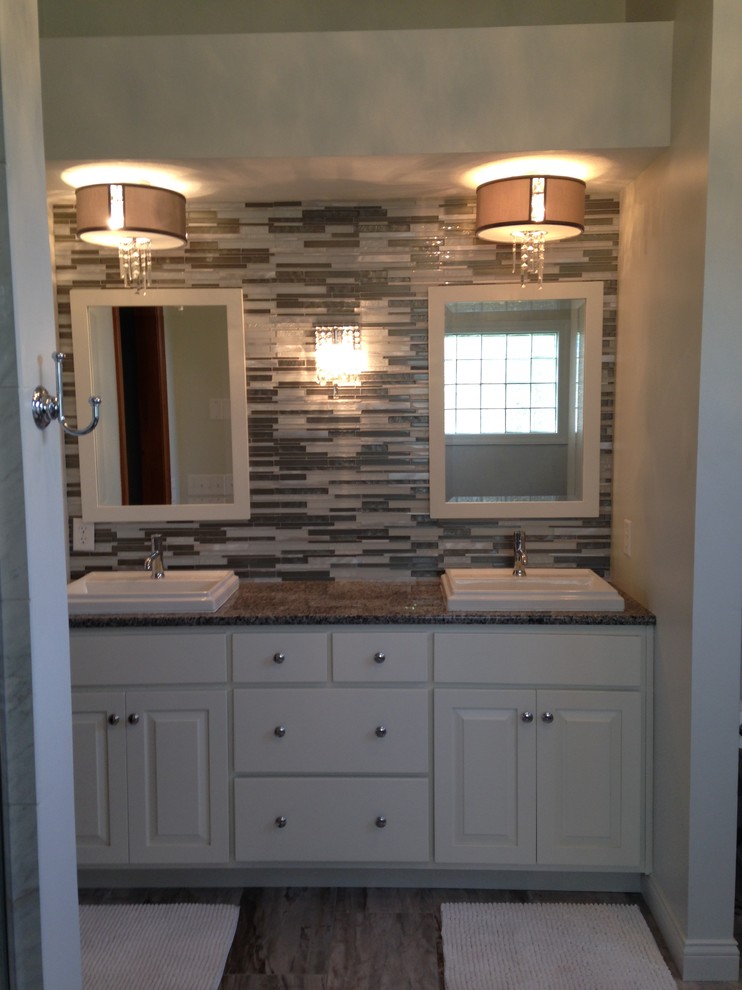 Bathroom - small transitional 3/4 mosaic tile plywood floor bathroom idea with raised-panel cabinets, white cabinets, beige walls, a vessel sink and granite countertops