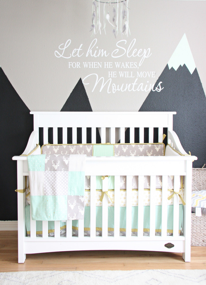 Design ideas for a large transitional nursery for boys in Austin with grey walls and light hardwood floors.