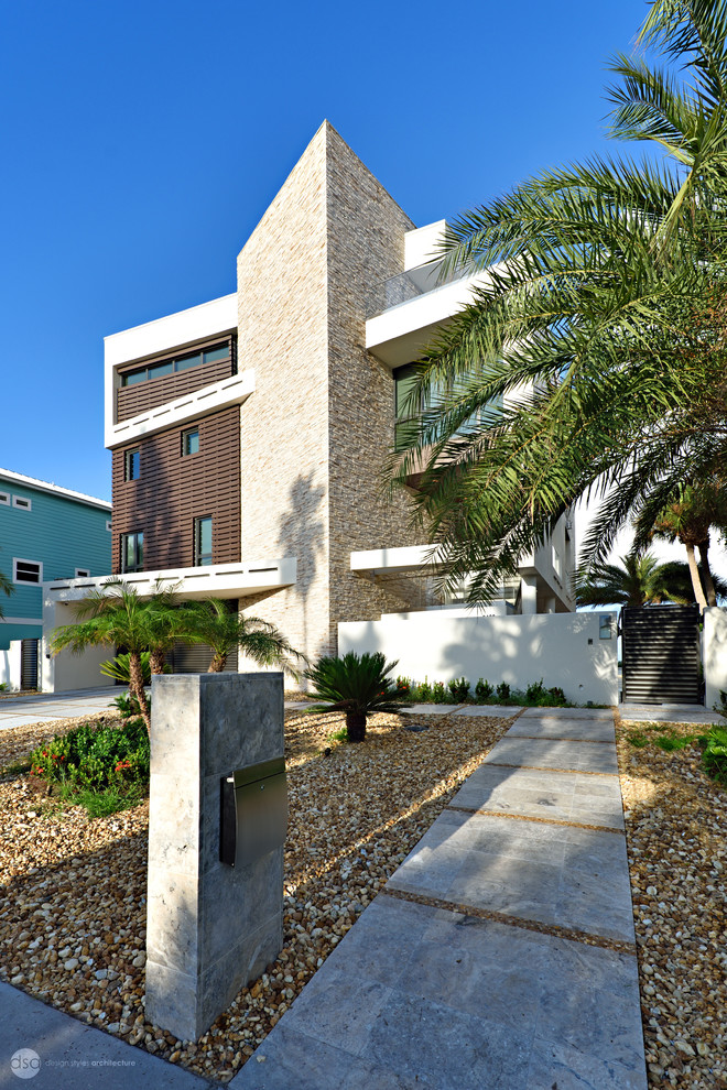 Photo of an expansive contemporary three-storey stucco white exterior in Tampa with a shed roof.