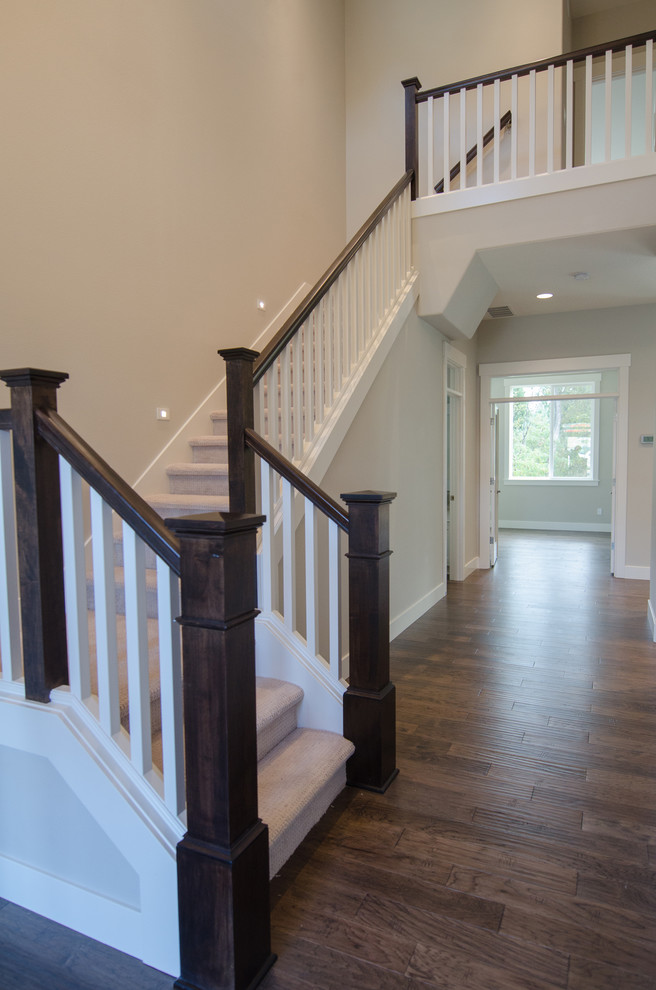Mid-sized transitional carpeted u-shaped staircase in Portland with carpet risers.