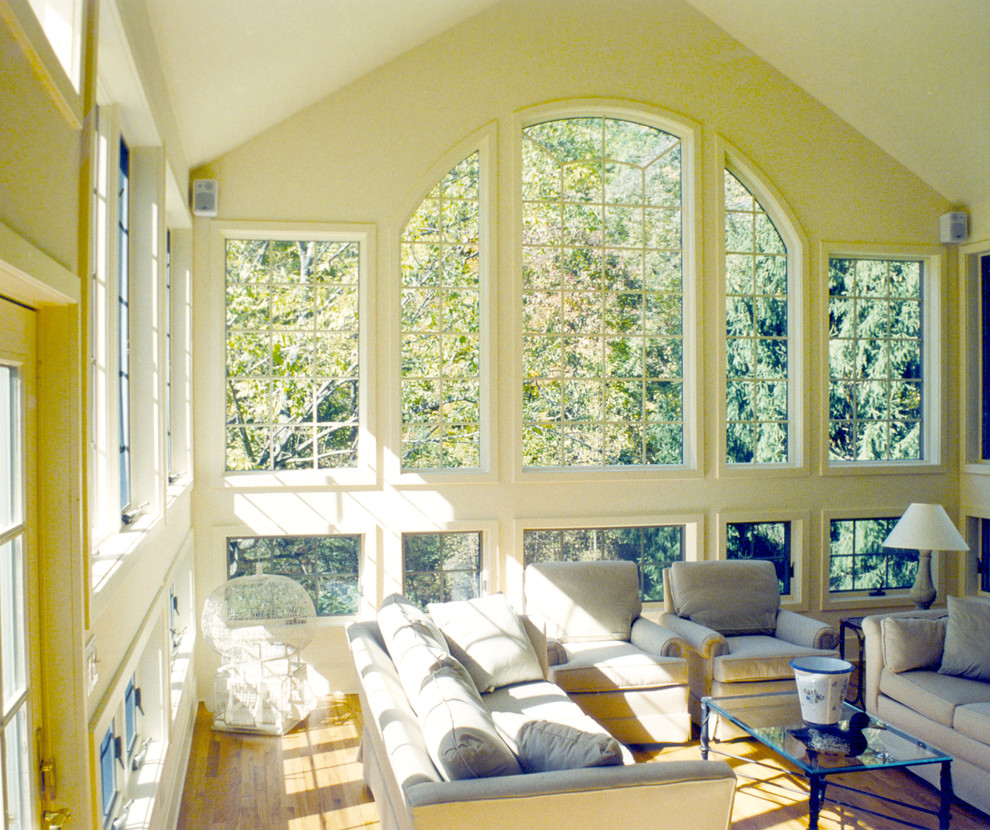 Photo of a mid-sized traditional sunroom in New York with light hardwood floors.