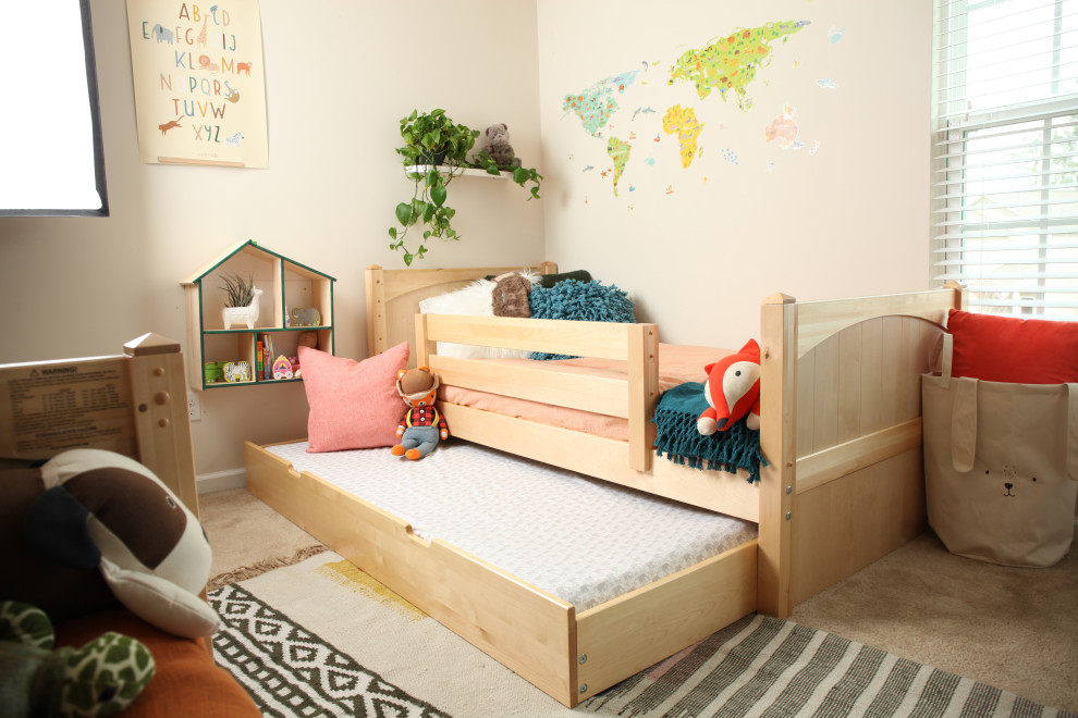 This is an example of a small bohemian gender neutral toddler’s room in Other with green walls.