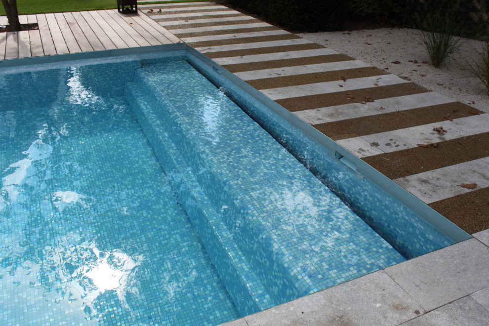 Inspiration for a large country side yard rectangular pool in Frankfurt with natural stone pavers.