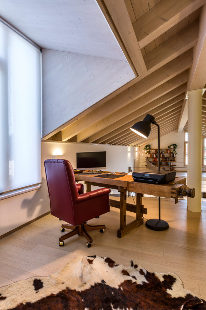 Photo of a contemporary home office in Other with white walls, light hardwood floors, a freestanding desk, beige floor, exposed beam and vaulted.