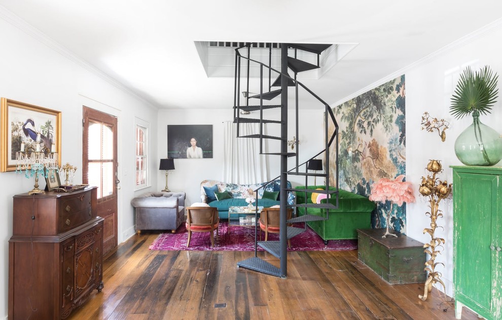 Eclectic living room in New Orleans with white walls, medium hardwood floors and brown floor.