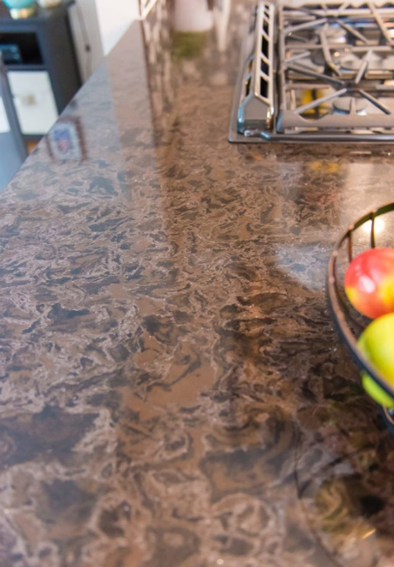 Mid-sized transitional galley medium tone wood floor and brown floor eat-in kitchen photo with an undermount sink, shaker cabinets, white cabinets, marble countertops, metallic backsplash, mosaic tile backsplash, stainless steel appliances and a peninsula