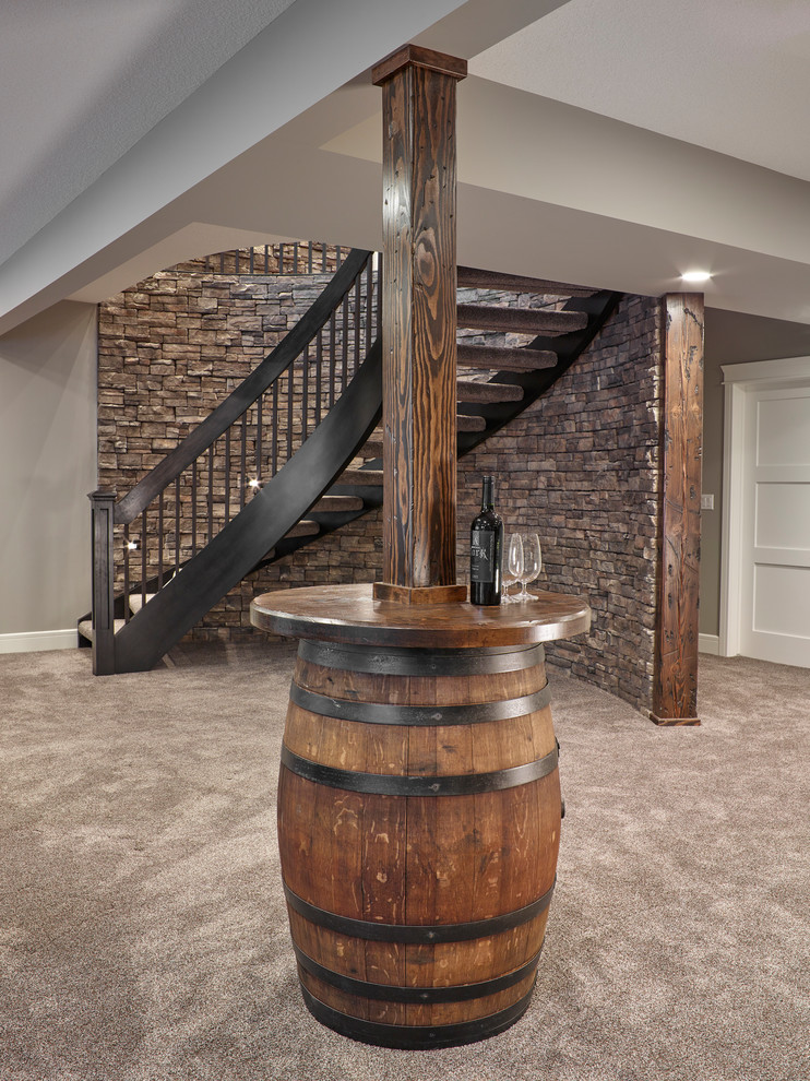 Large arts and crafts fully buried basement in Other with grey walls, carpet, a standard fireplace, a stone fireplace surround and grey floor.