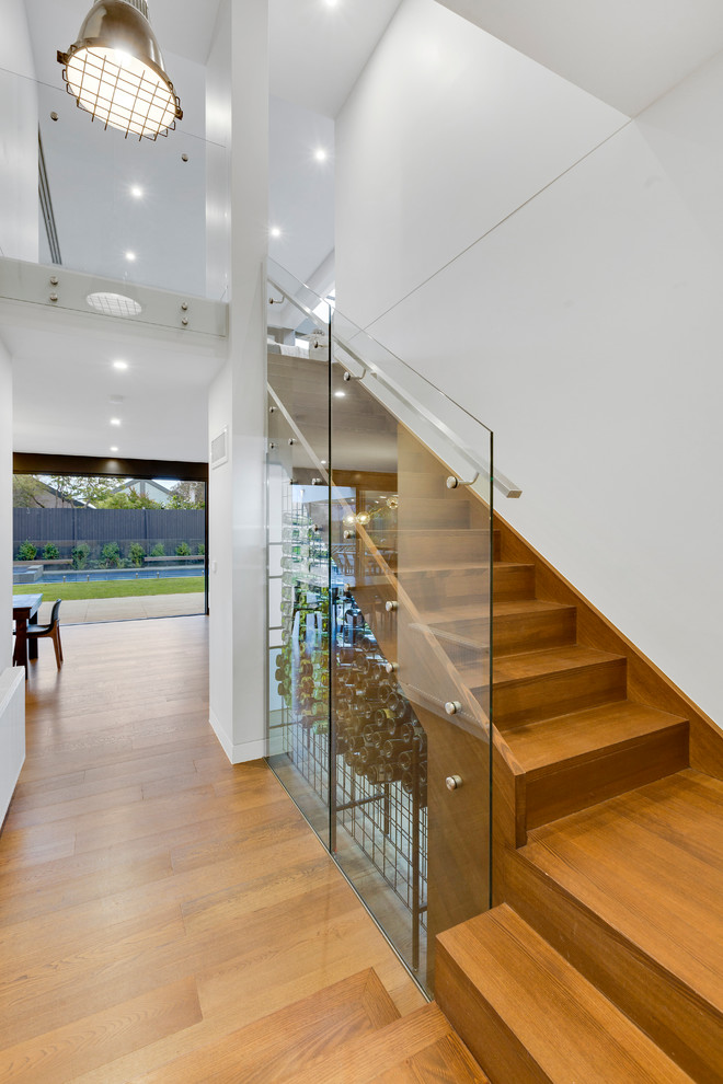 Design ideas for a modern wood l-shaped staircase in Melbourne with glass railing.