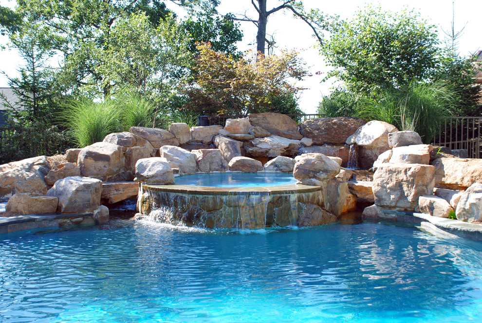 This is an example of an arts and crafts round pool in New York with a hot tub.