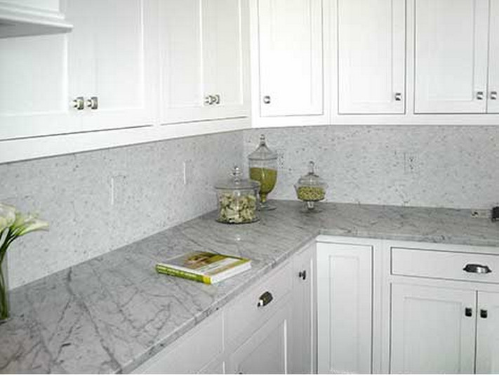 Example of a kitchen design in New York with recessed-panel cabinets, white cabinets, granite countertops and white backsplash