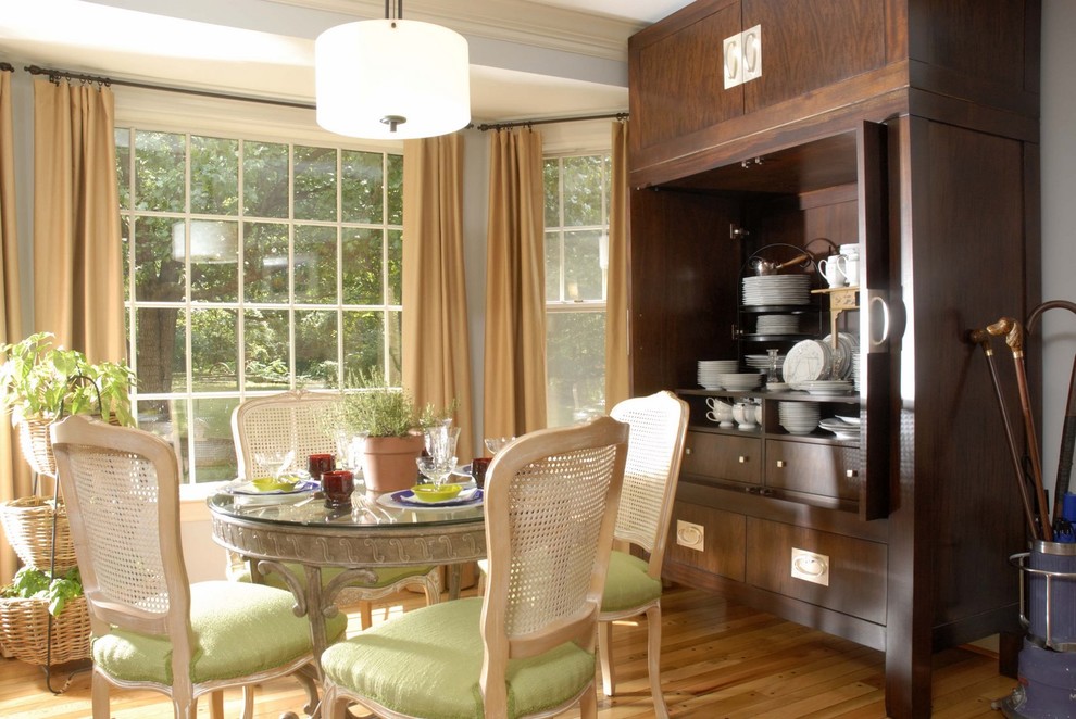 Photo of an eclectic dining room in Other with white walls and medium hardwood floors.