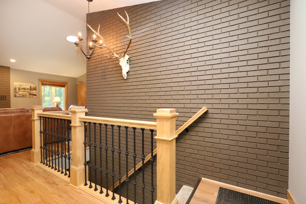 Front door - mid-sized transitional light wood floor and brown floor front door idea in Grand Rapids with gray walls and a white front door